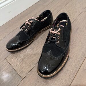 Ted Baker flat shoes with pink and black laces.